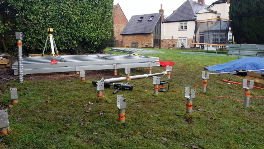 Ground screw foundation installation in a residential garden in Liverpool
