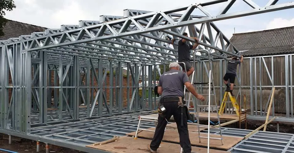 No Digging installers assembling a steel frame on ground screws